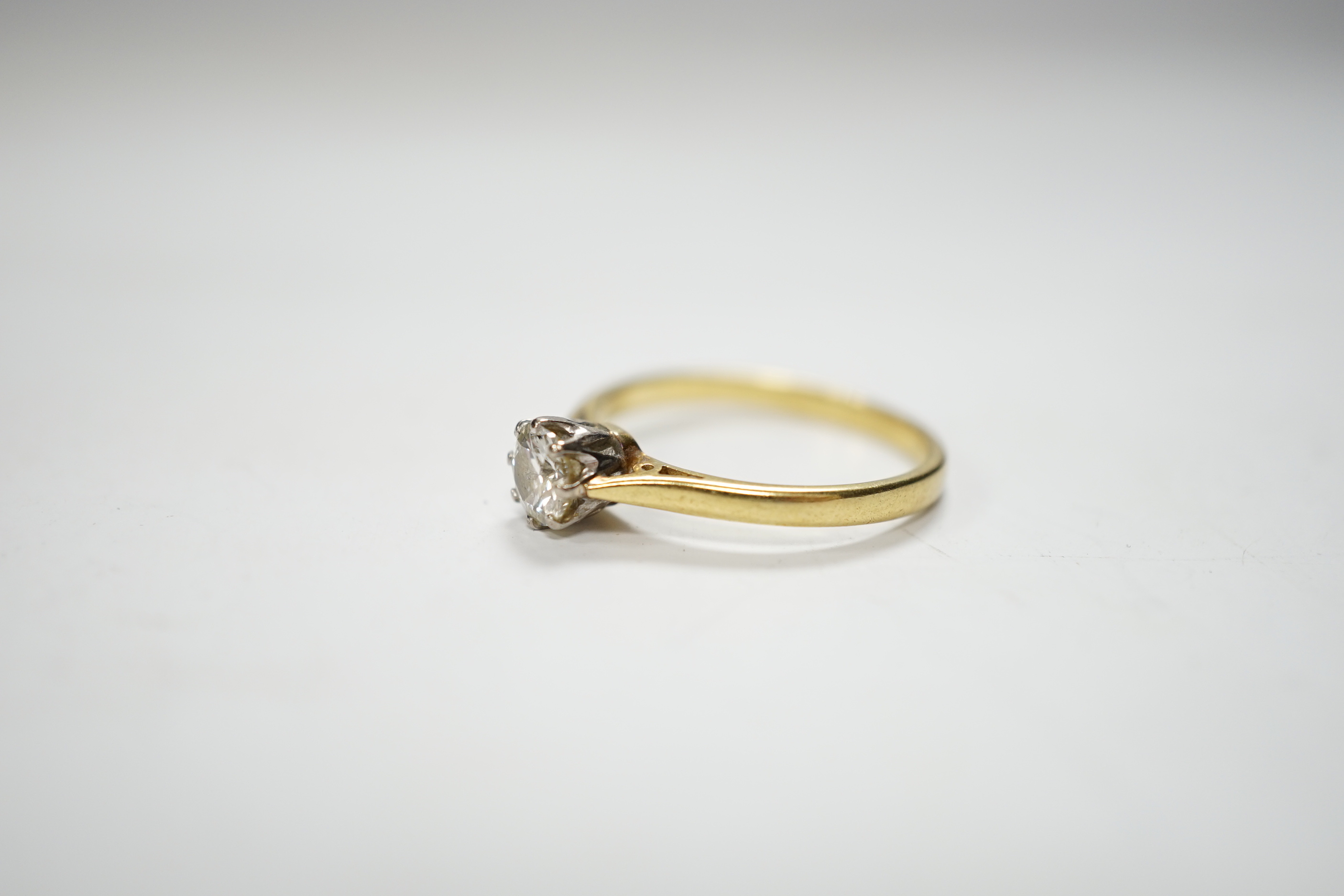 A modern 18ct gold and solitaire diamond ring, the stone measuring 5.2mm in diameter, size O/P, gross weight 2.9 grams.